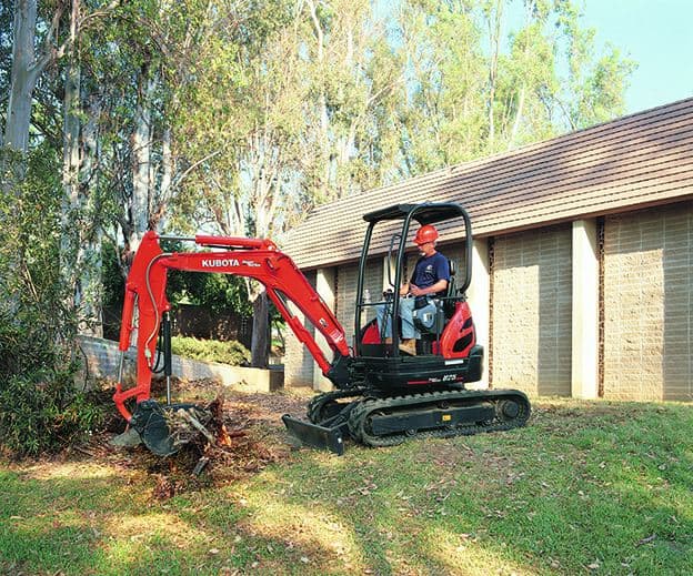 mini excavator operator using left joystick to move machine forward and boost engine speed